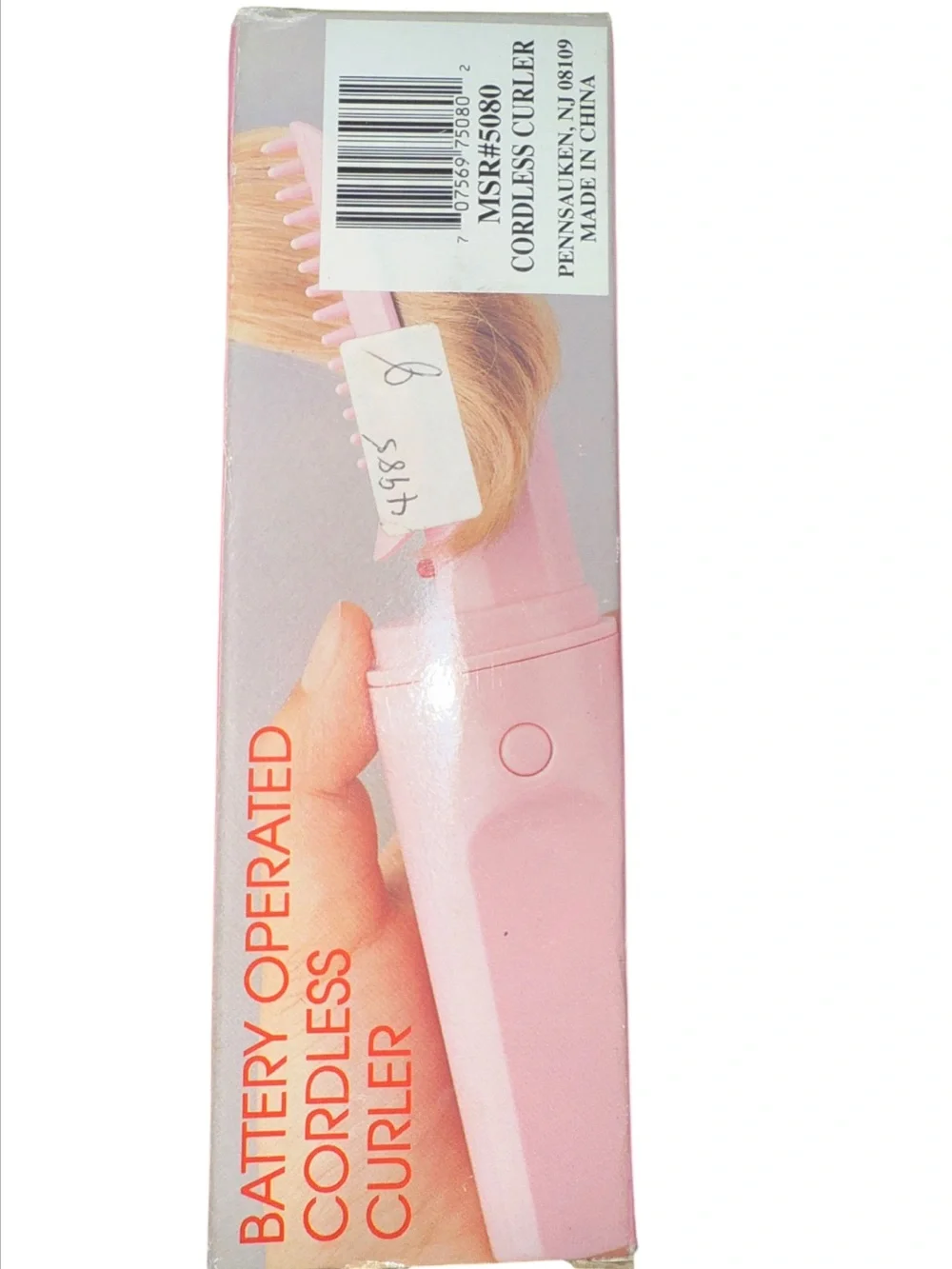 Vintage pink, portable battery-operated cordless hair curler and styling brush d